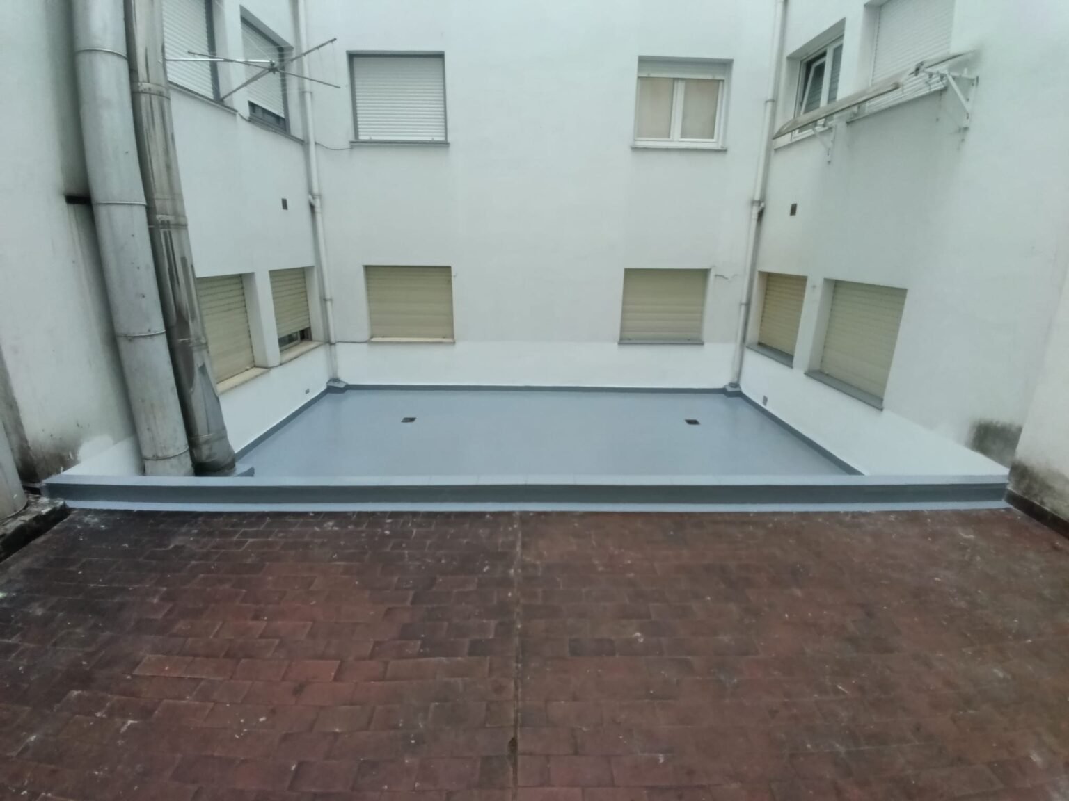 El mismo patio ya terminado en gris, visto desde el fondo